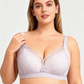 Woman wearing a bmama nursing bra with lace details on a plain background
