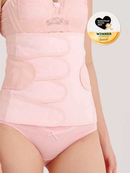 A woman wearing a pink bmama postpartum belly binder after pregnancy, with the product image displaying the brand logo and award badge.